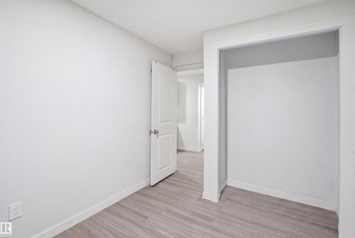Bright interior space with light wood-finish flooring, white walls, and a built-in alcove - 3545 11 Street, Edmonton, AB - Indoor Photo Showing Other Room