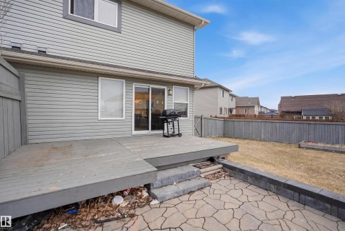 Rear exterior featuring light grey siding and a wooden deck with steps - 3545 11 Street, Edmonton, AB - Outdoor With Exterior