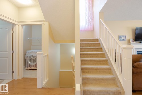 Carpeted staircase with white balusters and handrail - 7426 Getty Way, Edmonton, AB - Indoor Photo Showing Other Room