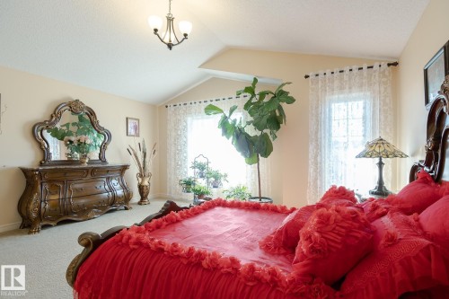 Vaulted ceiling with an overhead chandelier - 7426 Getty Way, Edmonton, AB - Indoor Photo Showing Bedroom