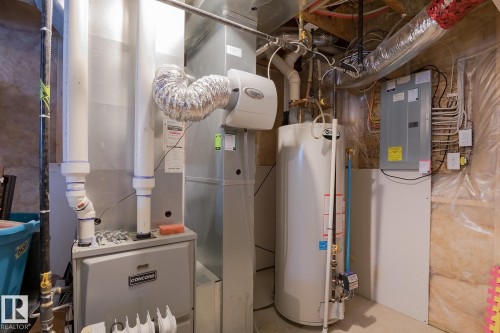 Utility area featuring a water heater, furnace, and electrical panel - 7426 Getty Way, Edmonton, AB - Indoor Photo Showing Basement
