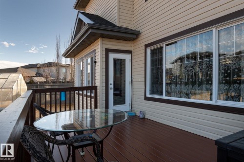 Expansive rear deck featuring wood-finish flooring, a full railing, and direct access to the interior via a glass-paneled door - 7426 Getty Way, Edmonton, AB - Outdoor With Deck Patio Veranda With Exterior