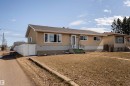 Single-story residence featuring a stucco exterior, white window trim, and a prominent front entrance with white railings - 13331 64 Street Nw, Edmonton, AB  - Outdoor 