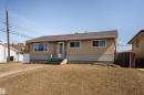 Light-colored stucco exterior with horizontal siding accents - 13331 64 Street Nw, Edmonton, AB  - Outdoor 