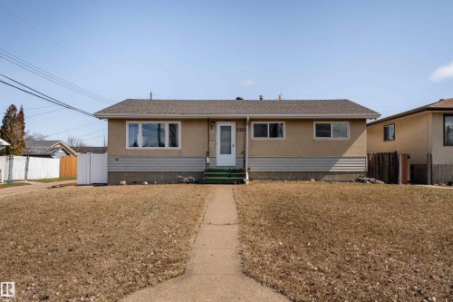 Stucco exterior with a pitched shingle roof - 13331 64 Street Nw, Edmonton, AB - Outdoor