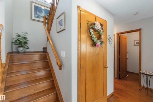 Hardwood staircase with natural wood handrail and balusters - 17224 83 Street, Edmonton, AB - Indoor Photo Showing Other Room