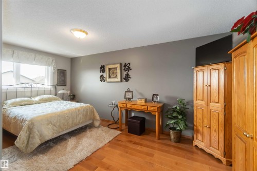 Bedroom featuring light wood-finish flooring, a neutral wall color, and a window with white trim - 17224 83 Street, Edmonton, AB - Indoor Photo Showing Bedroom