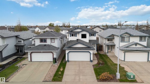White-sided exterior with dark gray shingles and trim - 17224 83 Street, Edmonton, AB - Outdoor With Facade