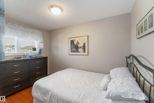 Bright room featuring a window with white window treatments, a flush-mount ceiling light fixture, and light-toned walls - 17224 83 Street, Edmonton, AB - Indoor Photo Showing Bedroom
