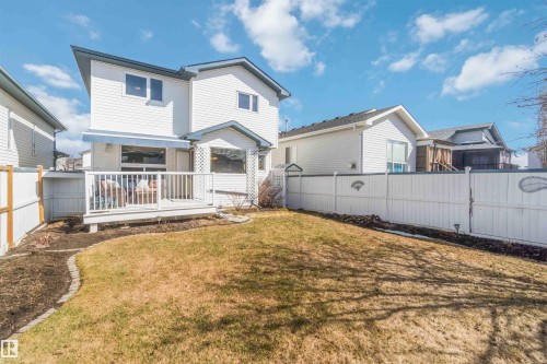 Spacious backyard with a large white deck and an expansive lawn area - 17224 83 Street, Edmonton, AB - Outdoor With Deck Patio Veranda