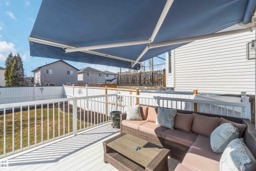 Deck featuring a retractable blue awning, white railing, and visible backyard space - 17224 83 Street, Edmonton, AB - Outdoor With Deck Patio Veranda With Exterior