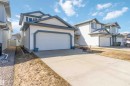 Two-story residence featuring light-colored siding with dark trim accents, an attached two-car garage, and a concrete driveway - 17224 83 Street, Edmonton, AB  - Outdoor 