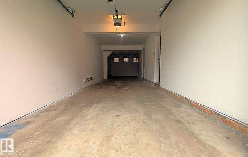 Expansive garage space featuring concrete flooring and painted walls - #11 13215 153 Avenue, Edmonton, AB - Indoor Photo Showing Other Room