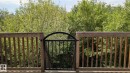 Wood deck featuring a black wrought iron gate with an arched top - #11 13215 153 Avenue, Edmonton, AB  - Indoor Photo Showing Living Room With Fireplace 