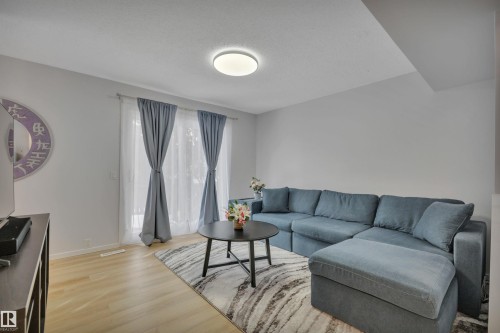 The living area features light-colored flooring, light walls, and a recessed ceiling light fixture - 585 Knottwood Road W, Edmonton, AB - Indoor Photo Showing Living Room