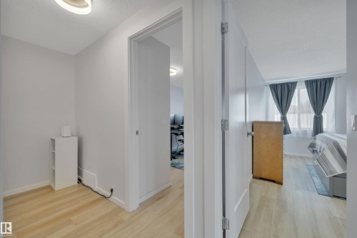 The property features light-colored flooring throughout the interior spaces - 585 Knottwood Road W, Edmonton, AB - Indoor Photo Showing Other Room