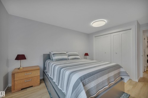 This bedroom features light wood flooring, light grey walls, and a recessed ceiling light fixture - 585 Knottwood Road W, Edmonton, AB - Indoor Photo Showing Bedroom