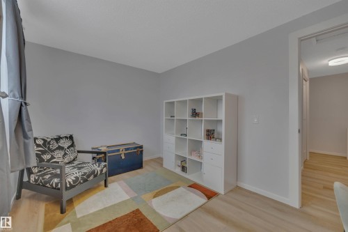This room features light-colored flooring, neutral-toned walls, and a doorway leading to an interior hallway - 585 Knottwood Road W, Edmonton, AB - Indoor Photo Showing Other Room