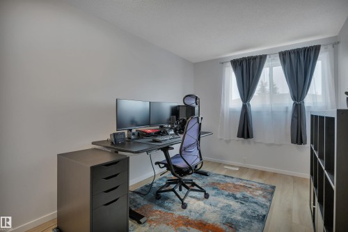 This room features light-colored walls and windows with curtains, creating a bright and inviting atmosphere - 585 Knottwood Road W, Edmonton, AB - Indoor Photo Showing Office