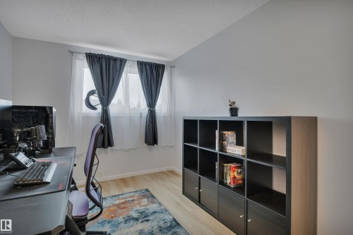 This room features light-toned flooring and white walls, creating a bright and airy atmosphere - 585 Knottwood Road W, Edmonton, AB - Indoor Photo Showing Other Room