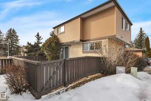 The property features a private fenced yard with a sliding glass patio door - 585 Knottwood Road W, Edmonton, AB - Outdoor