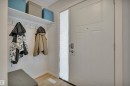 Entryway featuring a white paneled door with a sidelight, a coat rack with a shelf, and light-toned flooring - 585 Knottwood Road W, Edmonton, AB  - Indoor Photo Showing Other Room 