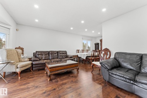 Spacious living area featuring wood-finish flooring, recessed lighting, and white walls - 16424 106 Street, Edmonton, AB - Indoor Photo Showing Living Room