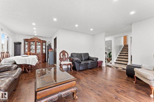 Open-concept living and dining area featuring wood-finish flooring, recessed lighting, and white walls - 16424 106 Street, Edmonton, AB - Indoor Photo Showing Living Room