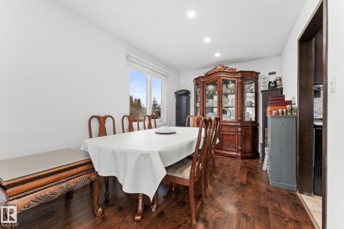 Dining area featuring warm wood-finish flooring, recessed lighting, and bright white walls - 16424 106 Street, Edmonton, AB - Indoor Photo Showing Dining Room