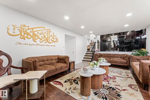 Open-concept living area featuring wood-finish flooring and recessed lighting - 16424 106 Street, Edmonton, AB - Indoor Photo Showing Living Room