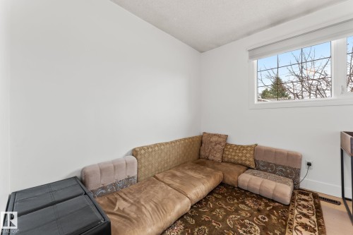 Bright room featuring a large window, neutral wall paint, and light-toned flooring - 16424 106 Street, Edmonton, AB - Indoor Photo Showing Living Room