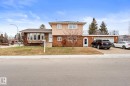 Two-story residence featuring a mixed-material facade with stone detailing and brickwork - 16424 106 Street, Edmonton, AB  - Outdoor 
