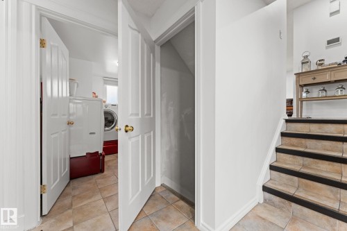 Tile flooring extending to the staircase, featuring dark risers - 16424 106 Street, Edmonton, AB - Indoor Photo Showing Other Room