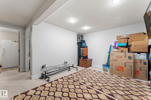 Spacious room featuring light-colored carpet, recessed lighting, and white walls - 16424 106 Street, Edmonton, AB - Indoor Photo Showing Bedroom