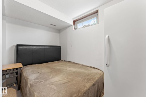 Carpeted room with a low-set window and white walls - 16424 106 Street, Edmonton, AB - Indoor Photo Showing Bedroom