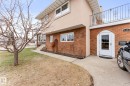 Brick facade with arched doorway entry and concrete walkway - 16424 106 Street, Edmonton, AB  - Outdoor 