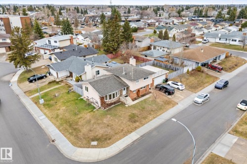 Corner lot property featuring a light-colored exterior, an attached garage, and a bay window - 16424 106 Street, Edmonton, AB - Outdoor With View