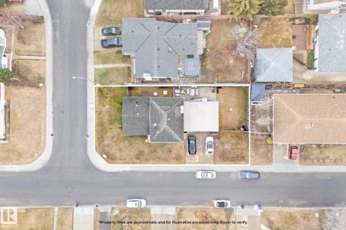 Aerial view showcasing a residential property with a shingled roof, a paved driveway, and a partially covered patio space - 16424 106 Street, Edmonton, AB - 