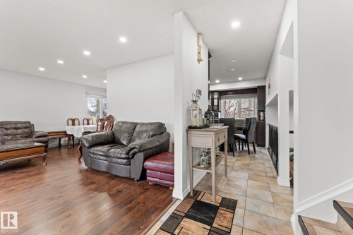 Open-concept living space featuring wood-finish flooring, recessed lighting, and white walls - 16424 106 Street, Edmonton, AB - Indoor Photo Showing Living Room