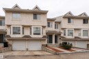 The property features a stucco exterior, gabled roofs, and bay windows - 3 9703 174 Street, Edmonton, AB  - Outdoor With Facade 
