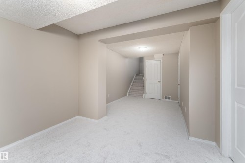 Spacious room featuring light-colored walls and wall-to-wall carpeting - 3 9703 174 Street, Edmonton, AB - Indoor Photo Showing Other Room