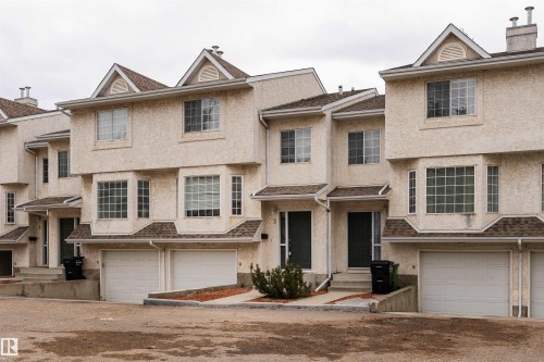 Property features a stucco exterior, gabled rooflines, and individual garage access - 3 9703 174 Street, Edmonton, AB - Outdoor With Facade