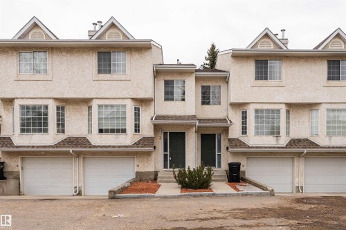 The property features a stucco exterior, gabled roof accents, and bay windows - 3 9703 174 Street, Edmonton, AB - Outdoor With Facade