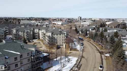 Aerial view of the neighborhood featuring residential buildings with balconies and paved roadways - 3 9703 174 Street, Edmonton, AB - Outdoor With View