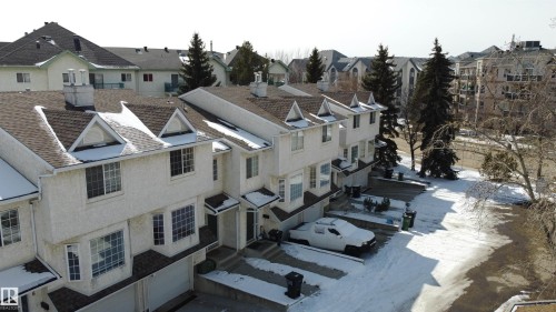 The property features a multi-story exterior with light-colored siding, dormer windows, and a shingled roof - 3 9703 174 Street, Edmonton, AB - Outdoor