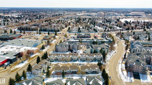 Aerial view showcasing the property's location within a developed neighborhood, featuring residential buildings and commercial establishments - 3 9703 174 Street, Edmonton, AB - Outdoor With View