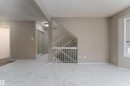Spacious room featuring light-colored carpet, neutral-toned walls, and a window with blinds - 3 9703 174 Street, Edmonton, AB  - Indoor Photo Showing Other Room 