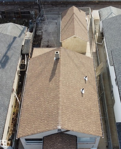 Pitched roof with dimensional shingles and a central chimney - 10644 96 Street, Edmonton, AB - 