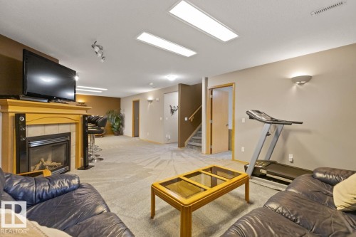 1 Birchwood Close, Leduc, AB - Indoor Photo Showing Gym Room With Fireplace