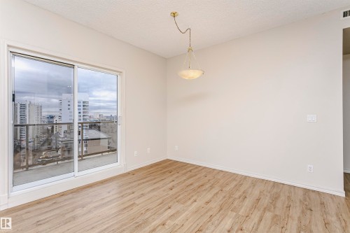 Sliding glass door opening to a balcony with city views - 1701 10649 Saskatchewan Drive, Edmonton, AB - Indoor Photo Showing Other Room